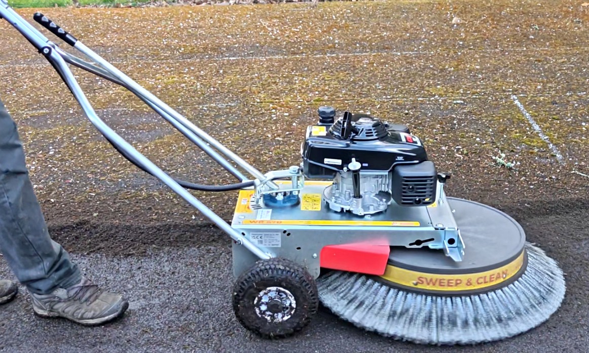 Professional sweep and clean machine in use on a driveway